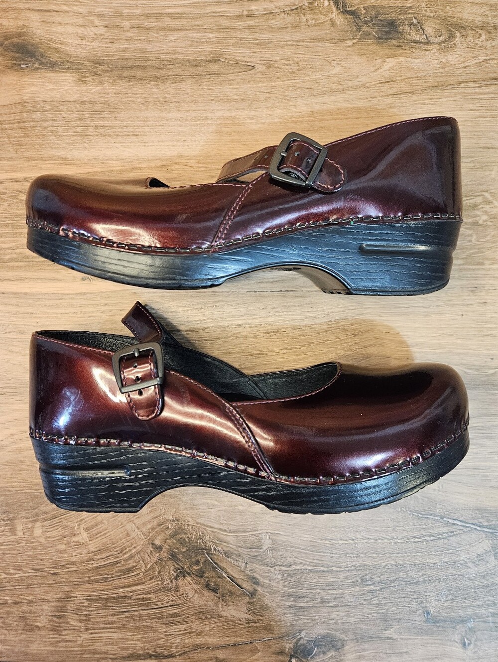 Dansko Marcelle Mary Jane Clogs in a glossy burgundy patent leather. Size 41
